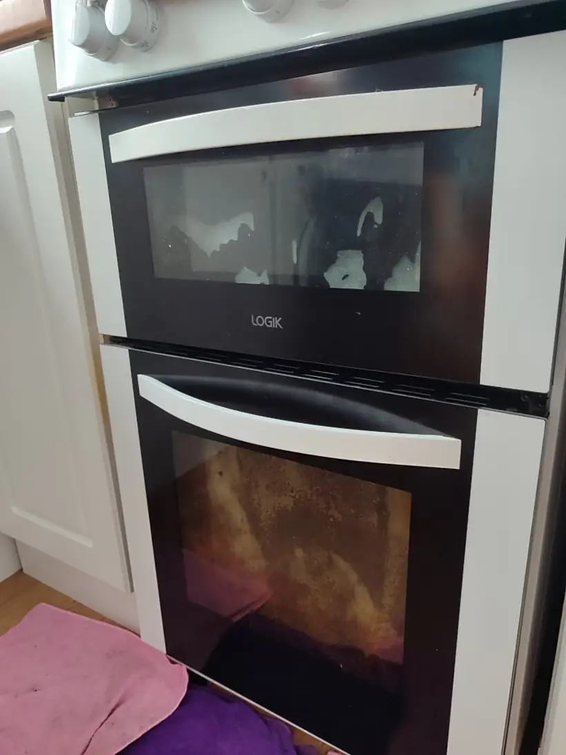 Double oven in Letterkenny before a deep clean: baked-on grease on both door glasses