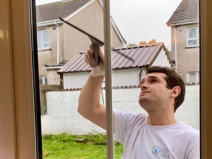 Yevhen cleaning a window in a Donegal home